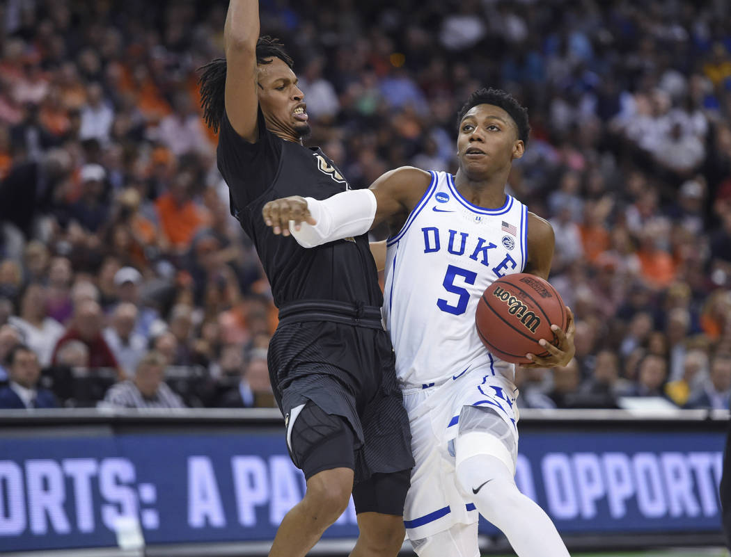 Duke's RJ Barrett (5) drives while defended by Central Florida's Terrell Allen during the second half of a second-round men's college basketball game in the NCAA Tournament in Columbia, S.C., Sund ...