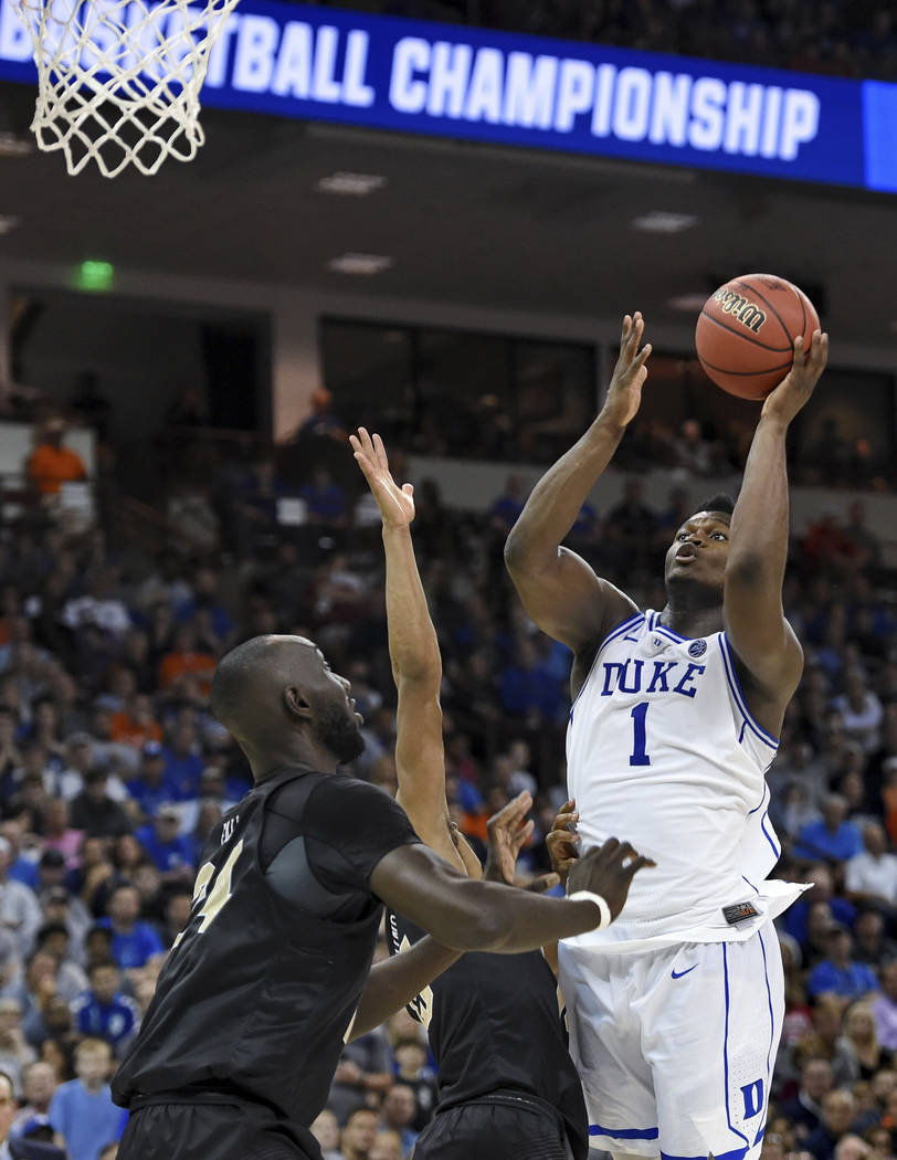Duke's Zion Williamson shoots over Central Florida's Tacko Fall during the second half of a second-round men's college basketball game in the NCAA Tournament in Columbia, S.C. Sunday, March 24, 20 ...