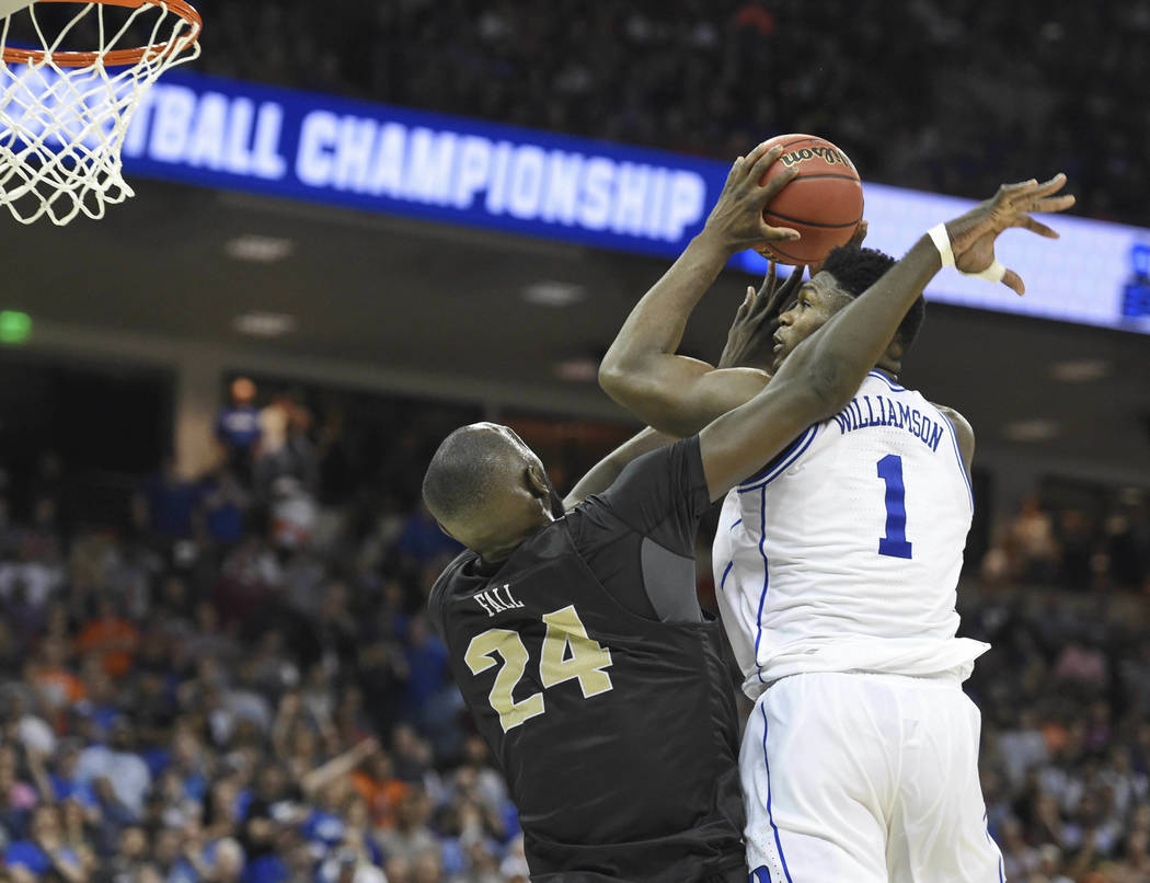 Duke's Zion Williamson (1) shoots while defended by Central Florida's Tacko Fall (24) during the second half of a second round men's college basketball game in the NCAA Tournament in Columbia, S.C ...