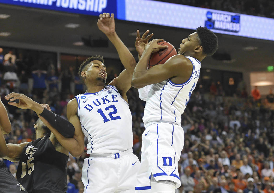 Duke's RJ Barrett, right, grabs a rebound with help from teammate Javin DeLaurier (12) after a missed free throw by Zion Williamson, that led to Barrett scoring the game -winning basket against Ce ...