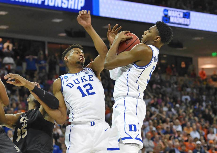 Duke's RJ Barrett, right, grabs a rebound with help from teammate Javin DeLaurier (12) after a missed free throw by Zion Williamson, that led to Barrett scoring the game -winning basket against Ce ...