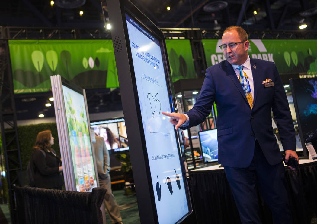 Brian McClimans, vice president of sales at Peerless-AV, shows off an all-in-one digital kiosk ...