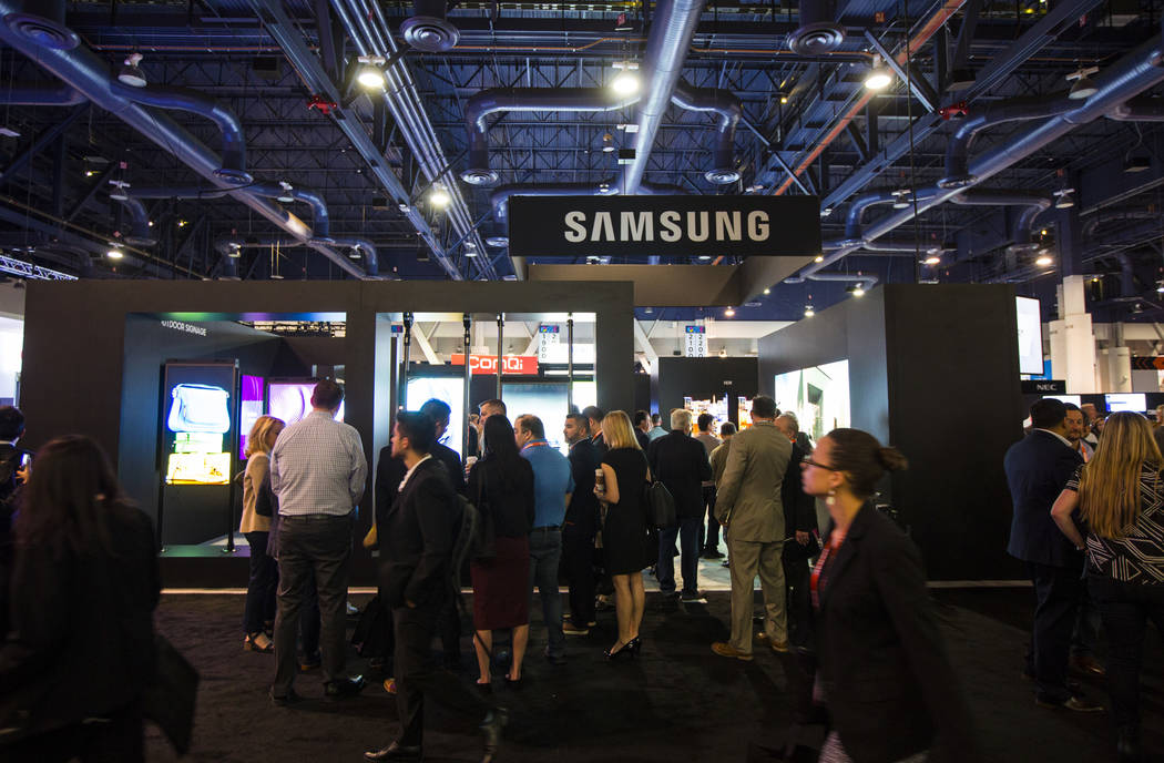 Attendees walk by the Samsung booth at the Digital Signage Expo at the Las Vegas Convention Cen ...