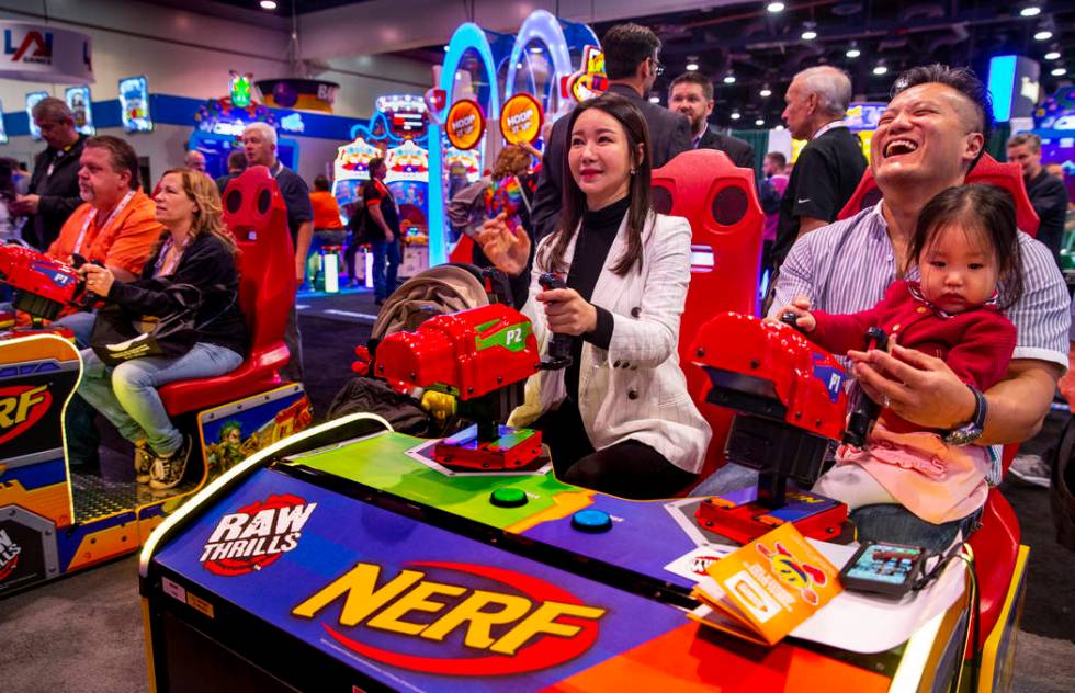 Hwa Yeon Lee with husband James and daughter Vivian, 2, with FunXcess enjoy a turn on the Nerf ...