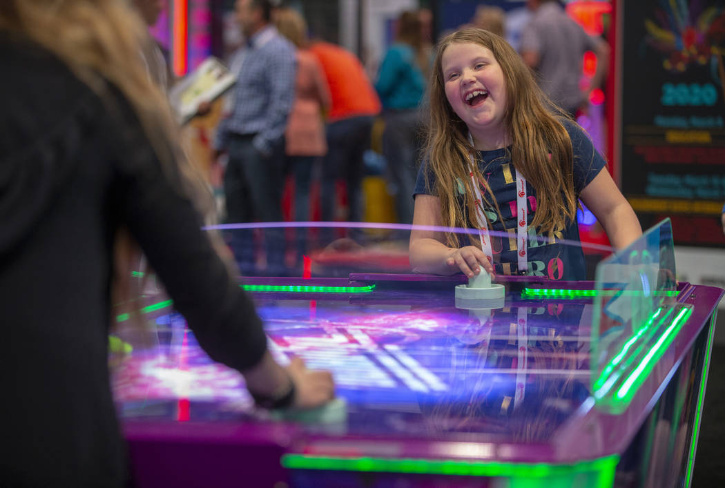 Evva Fortier with Gamepath Arcade plays air hockey with a friend during the Amusement Expo at t ...