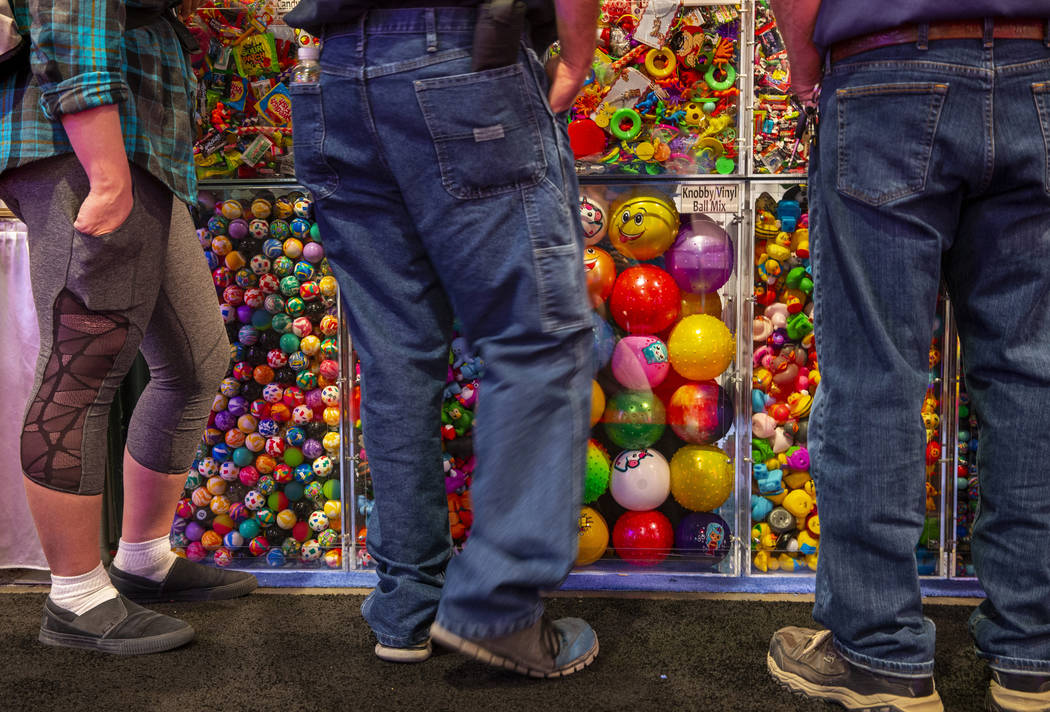 Attendees view some of the many game prizes for sale during the Amusement Expo at the Las Vegas ...