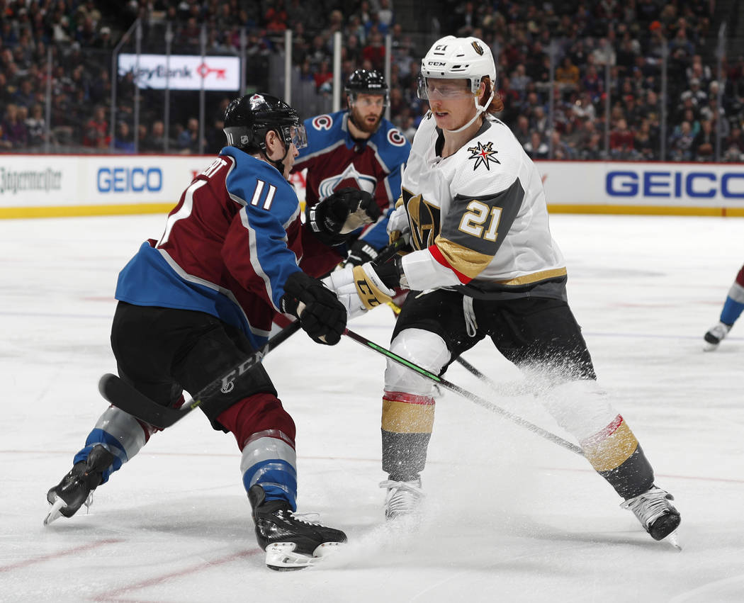 Vegas Golden Knights center Cody Eakin, right, gets tied up by Colorado Avalanche left wing Mat ...