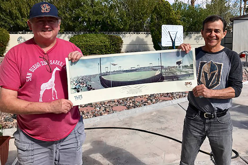 Rene LaComb, left, and Craig Lake hold a commemorative print given to fans at first baseball ga ...