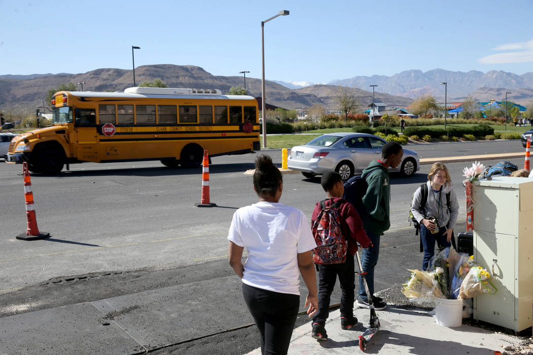 People visit a memorial at the intersection of South Fort Apache Road and West Arby Avenue at a ...