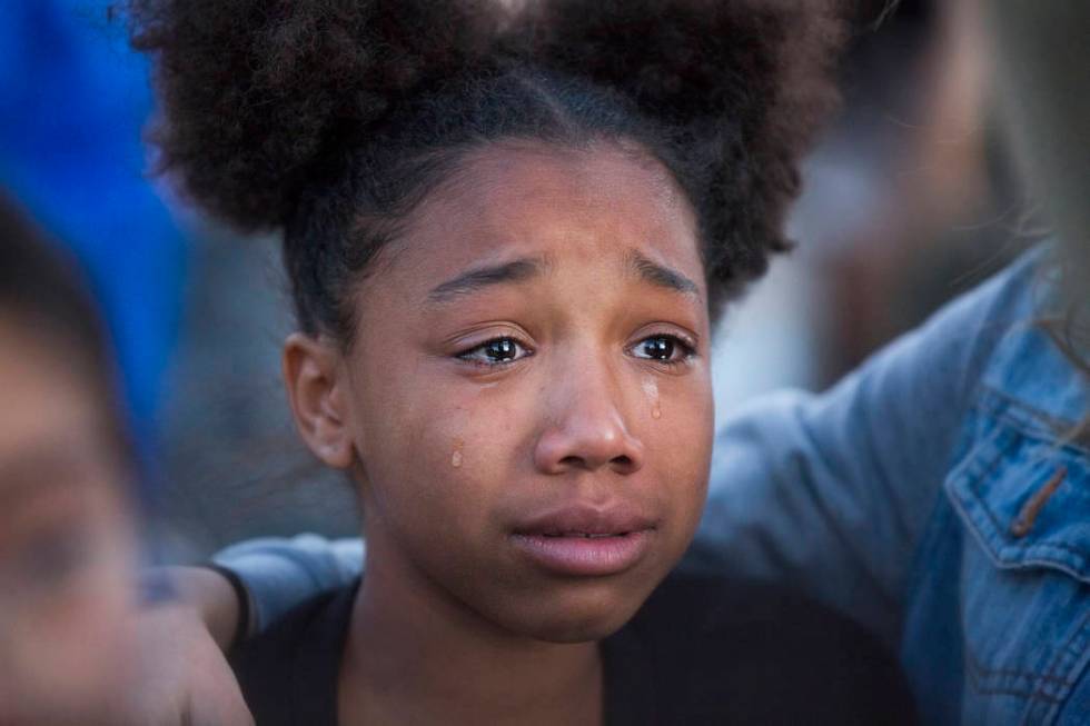 Friends and family mourn the loss of Jonathan Smith, 12, during a vigil for Smith at Wilbur &am ...