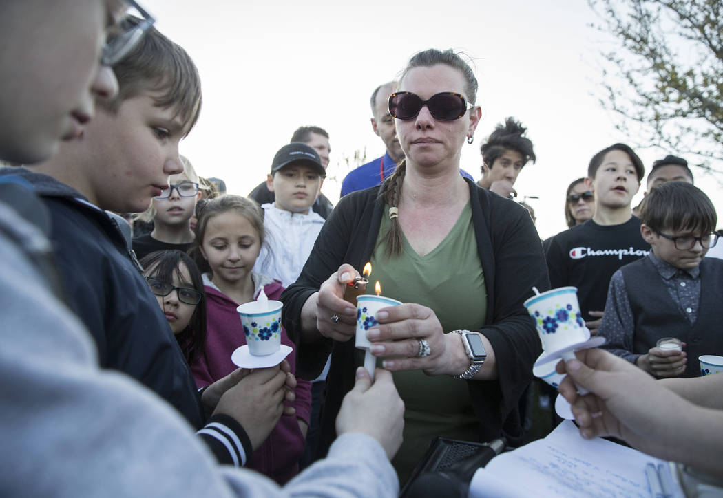 Friends and family light candles during a vigil for Jonathan Smith, 12, at Wilbur & Theres ...