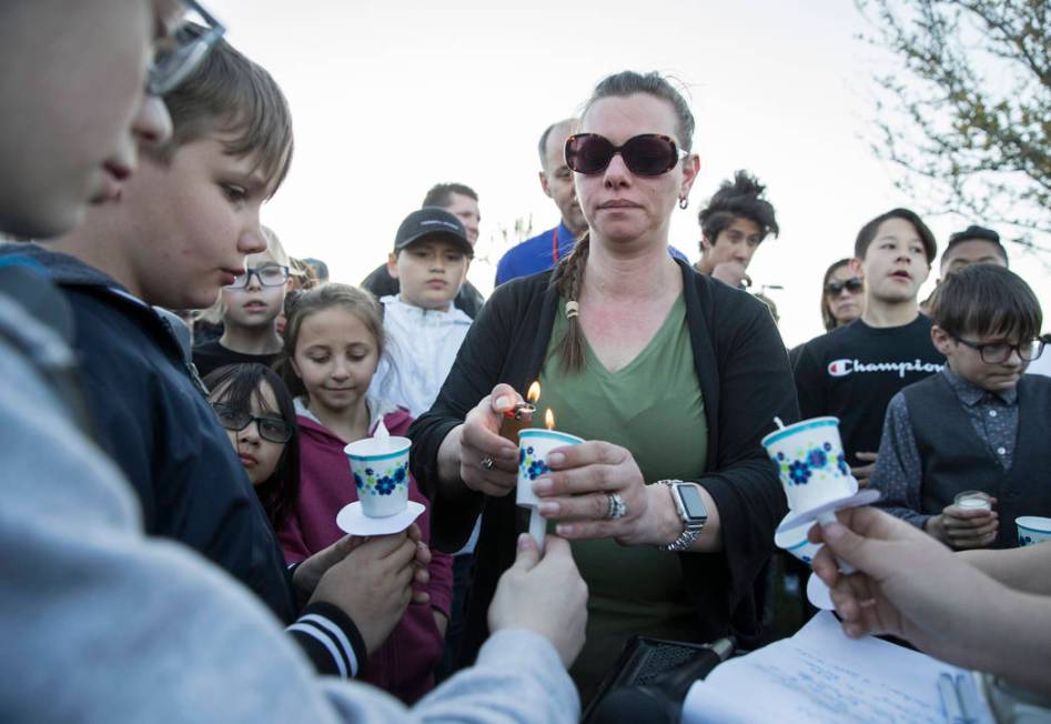 Friends and family light candles during a vigil for Jonathan Smith, 12, at Wilbur & Theres ...