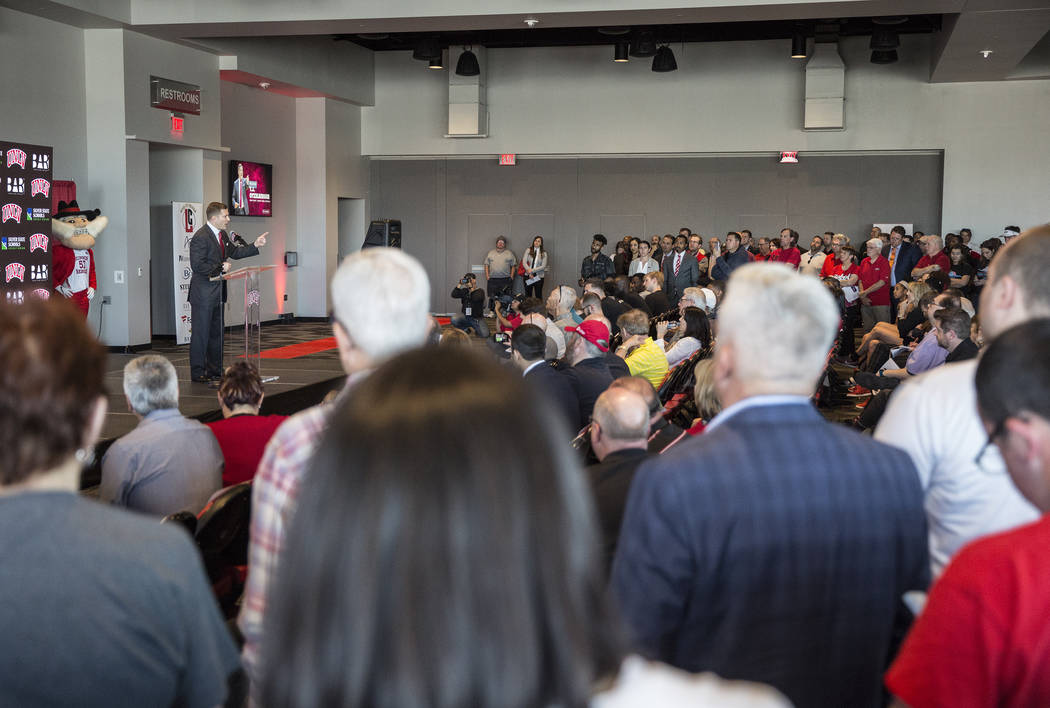 New UNLV men's basketball coach T.J. Otzelberger, left/top, addresses the crowd at the Strip Vi ...