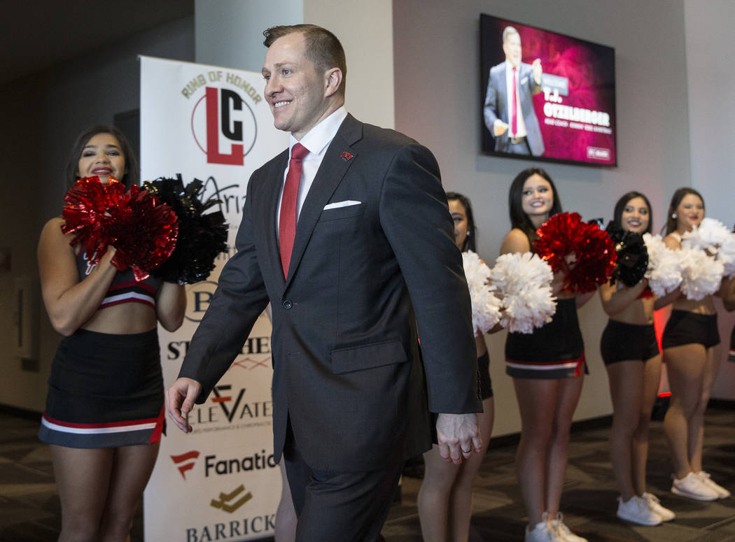 New UNLV men's basketball coach T.J. Otzelberger walks to the podium at the Strip View Pavilion ...