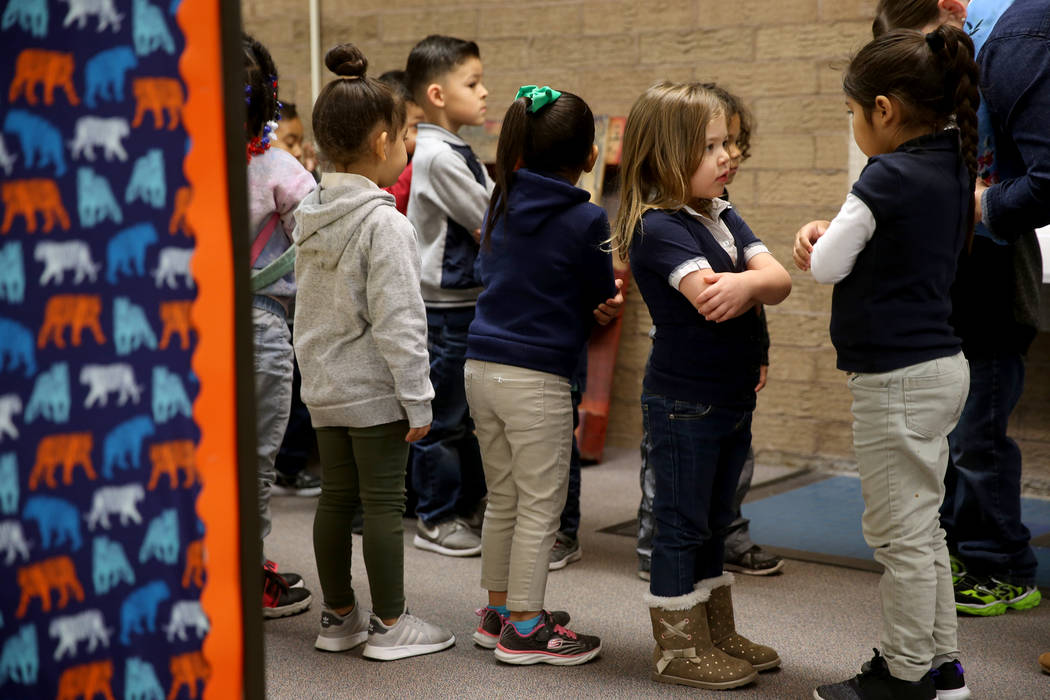 Prekindergarten students Mia Caamano Palafox, right, and Iris Vazquez prepare to walk to class ...