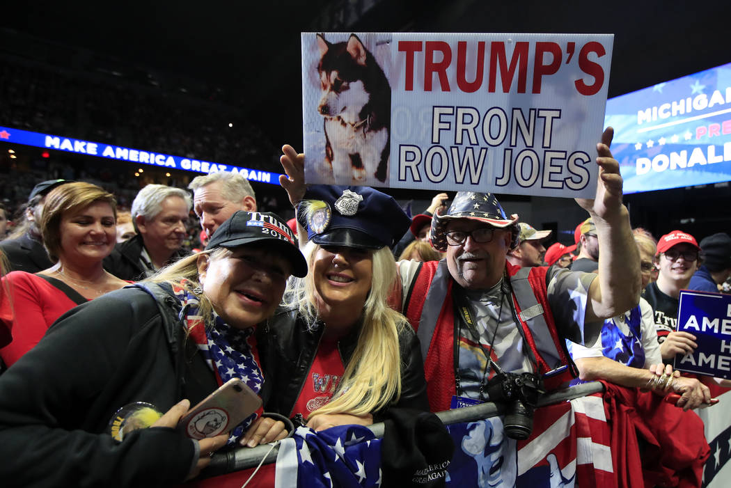 People cheer as President Donald Trump speaks at a campaign rally in Grand Rapids, Mich., Thurs ...