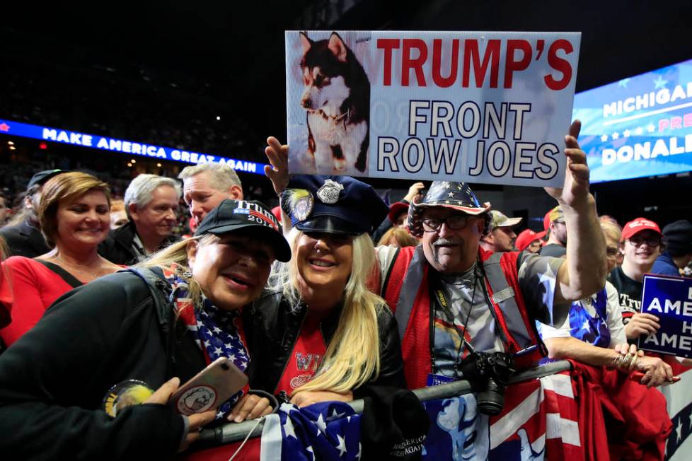 People cheer as President Donald Trump speaks at a campaign rally in Grand Rapids, Mich., Thurs ...