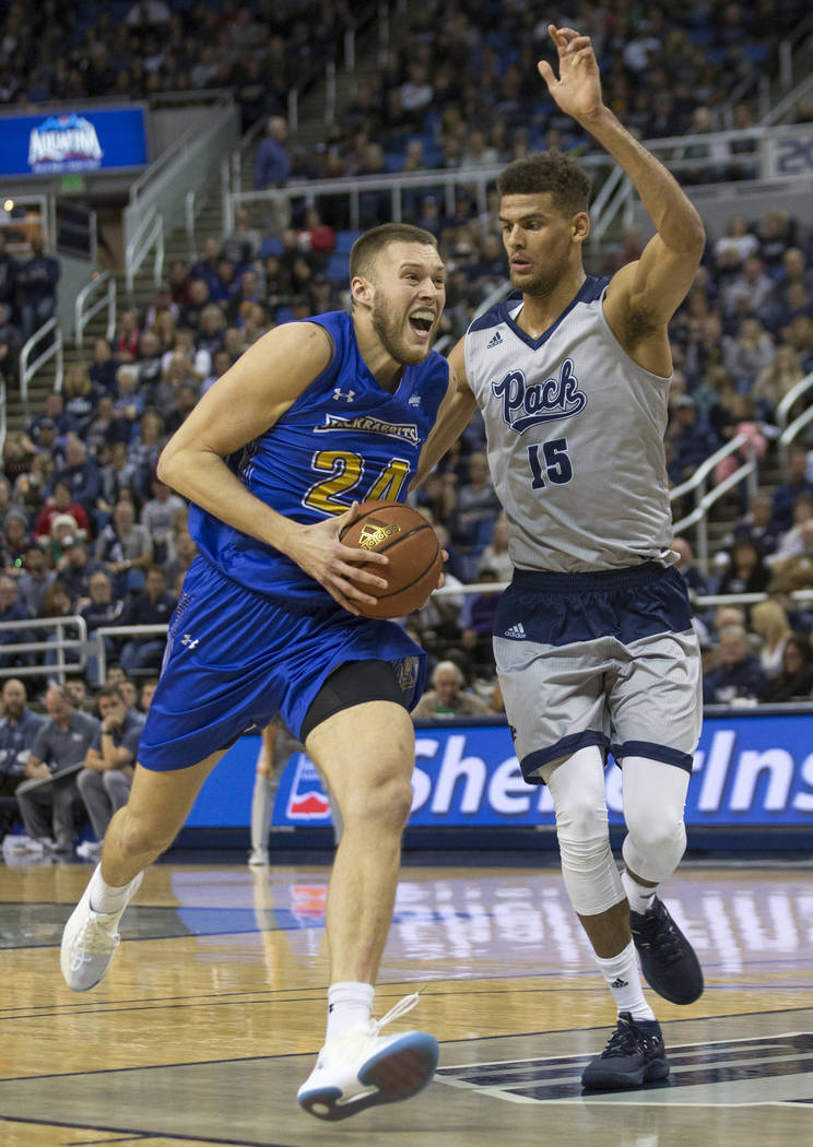 South Dakota State forward Mike Daum (24) drives in the lane against Nevada's Trey Porter (15) ...