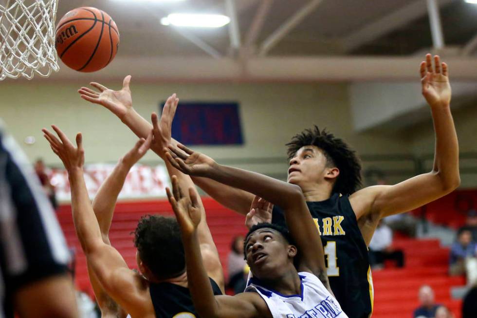 Clark's Jalen Hill, right, battles for a rebound against Desert Pines' Dayshawn Wiley (2) durin ...