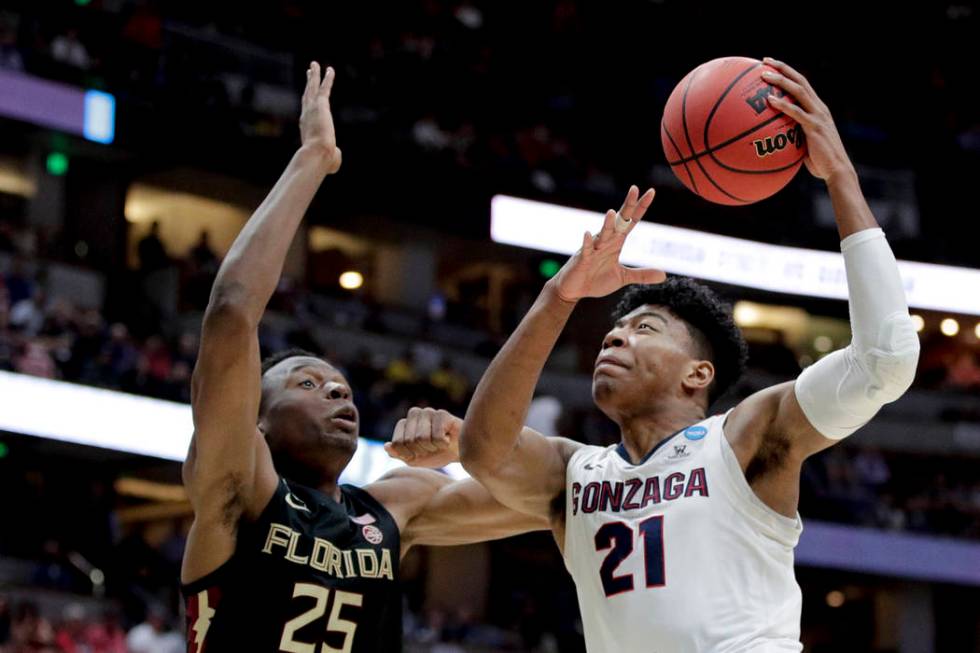 Gonzaga forward Rui Hachimura, right, shoots over Florida State forward Mfiondu Kabengele durin ...