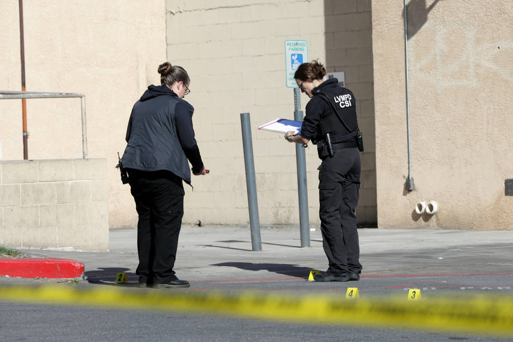 Las Vegas police crime scene investigators document evidence at a gas station at the corner of ...