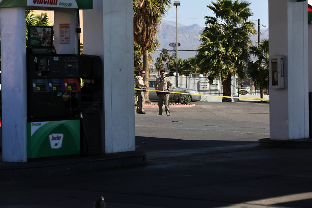 Las Vegas police officers block off a gas station at the corner of Washington Avenue and Las Ve ...