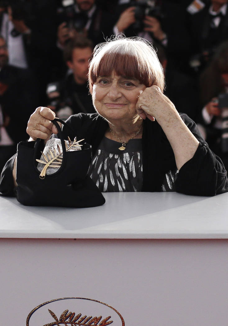 FILE - In this Sunday, May 24, 2015 file picture, director Agnes Varda holds the Honorary Palme ...