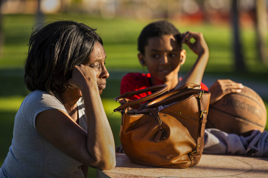 Reponzia Catron and her son Marion, 16, spend some time in Huntridge Circle Park which has long ...