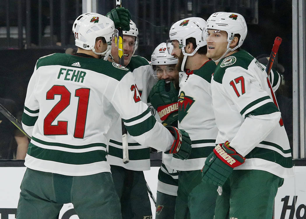 Minnesota Wild players celebrate after defenseman Greg Pateryn, second from right, scored again ...