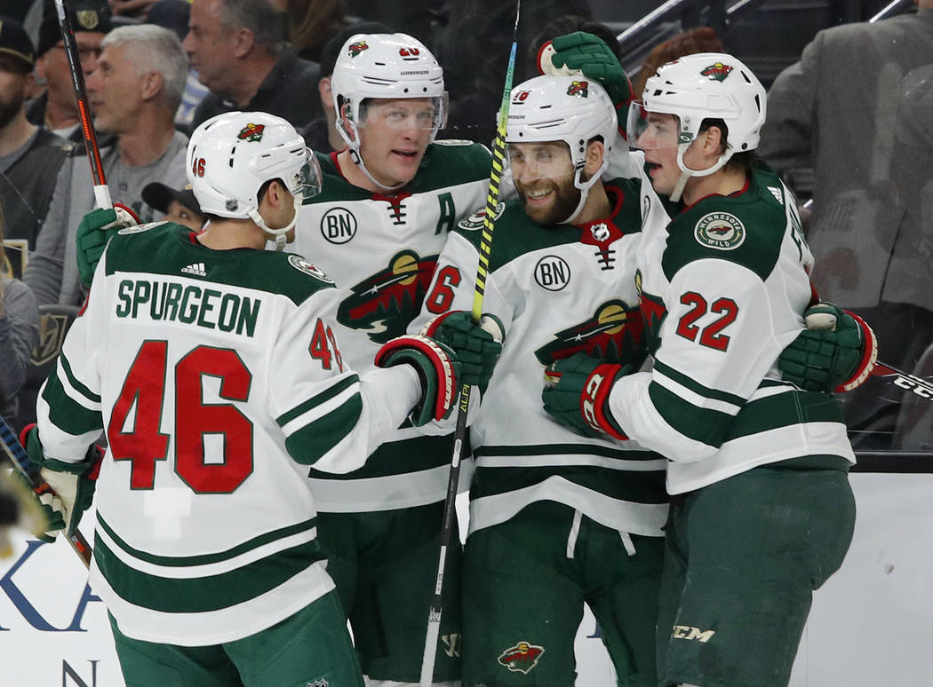 Minnesota Wild players celebrate after Jason Zucker, second from right, scored against the Vega ...