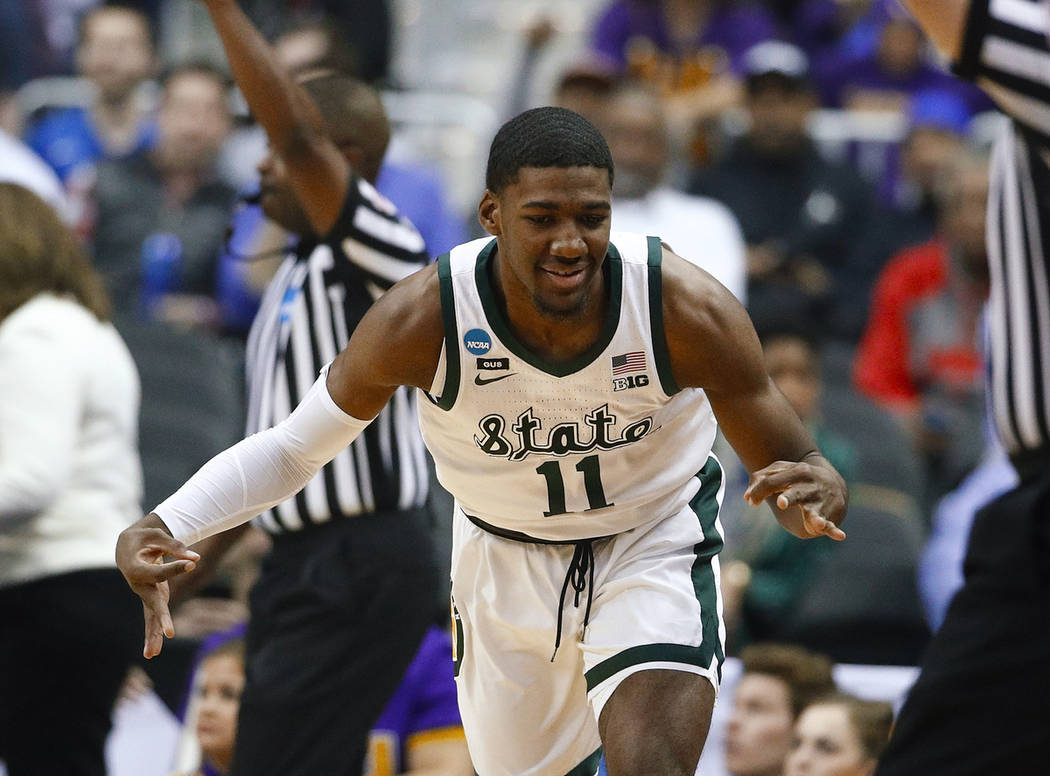 Michigan State forward Aaron Henry gestures after making a 3-pointer against LSU during the fir ...