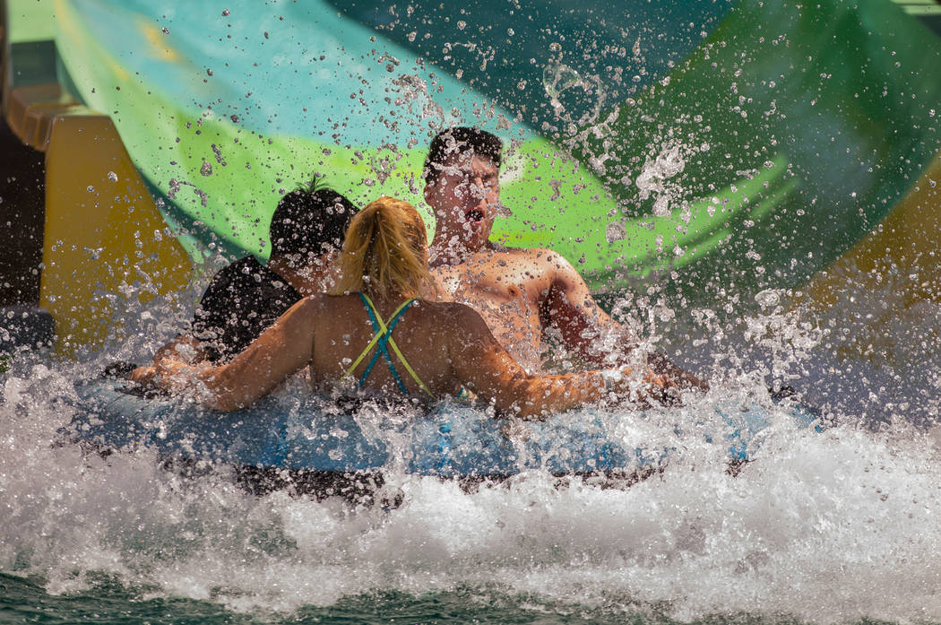 Riders hit the water at the end of the Beach Blanket Banzai slide during opening day for the se ...