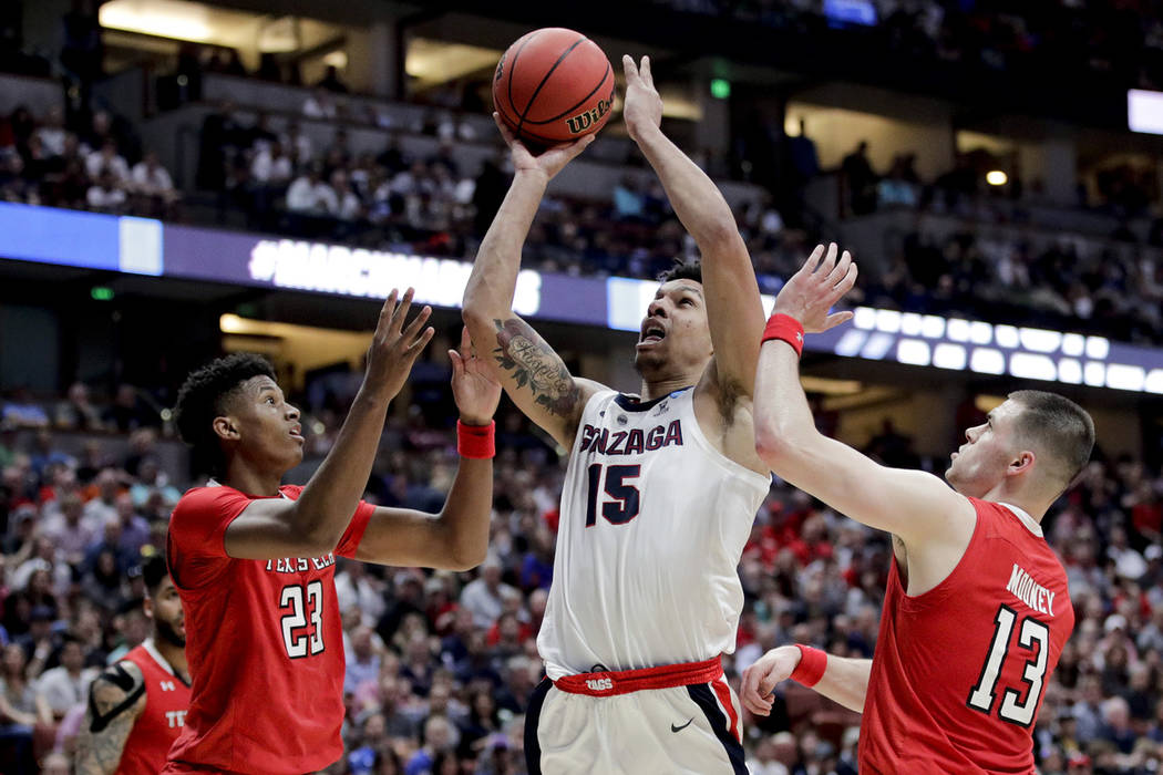 Gonzaga guard Zach Norvell Jr. shoots between Texas Tech guards Jarrett Culver, left, and Matt ...