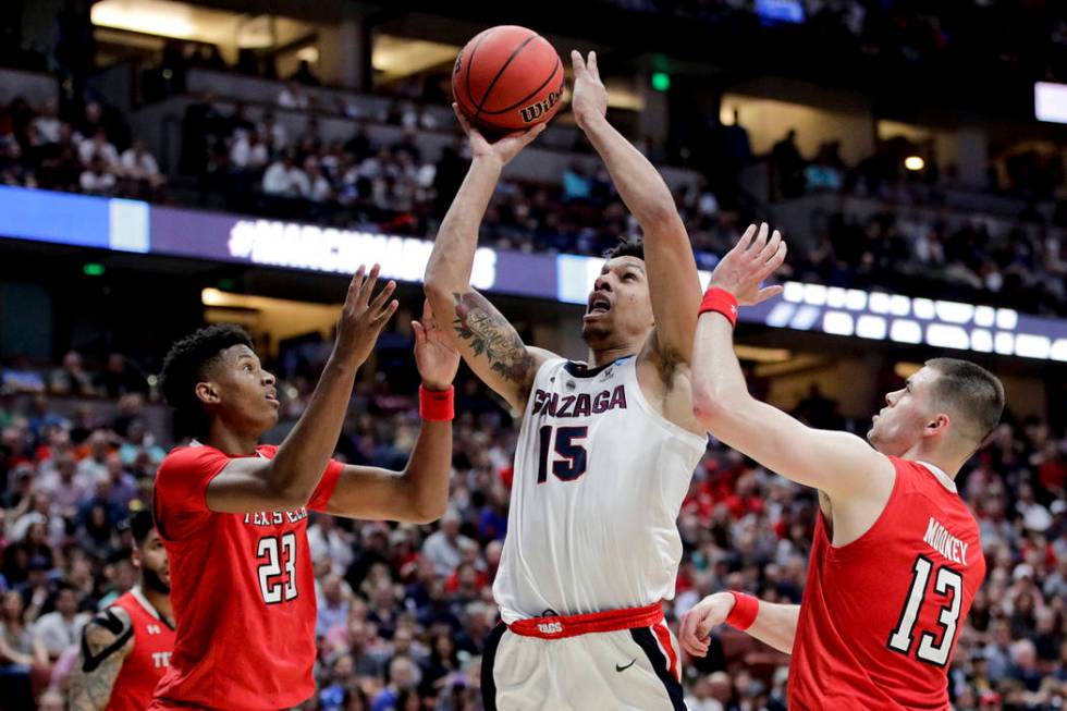 Gonzaga guard Zach Norvell Jr. shoots between Texas Tech guards Jarrett Culver, left, and Matt ...