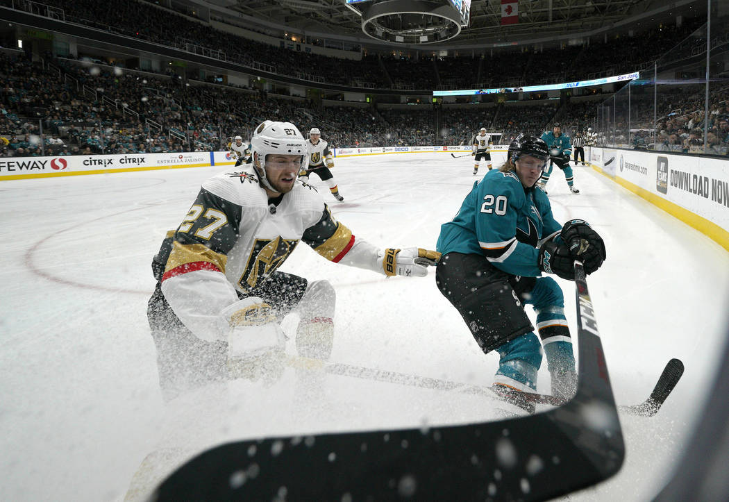 Vegas Golden Knights defenseman Shea Theodore (27) battles for the puck against San Jose Sharks ...