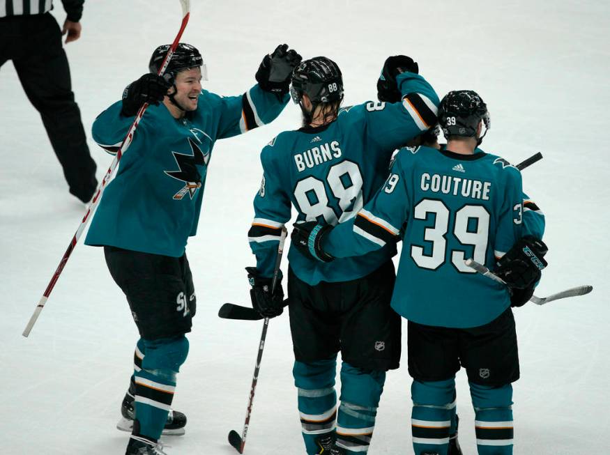 San Jose Sharks defenseman Brent Burns (88) celebrates with teammates Tomas Hertl, left, and Lo ...