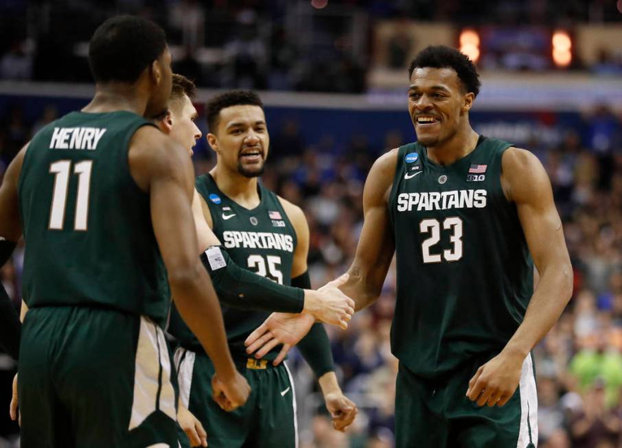 Michigan State forward Xavier Tillman (23) celebrates with teammates after scoring against Duke ...