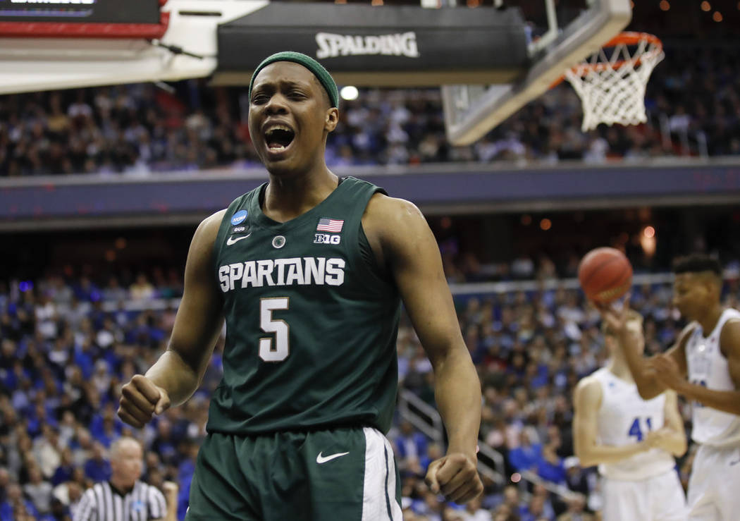 Michigan State guard Cassius Winston (5) reacts to scoring on Duke during the first half of an ...