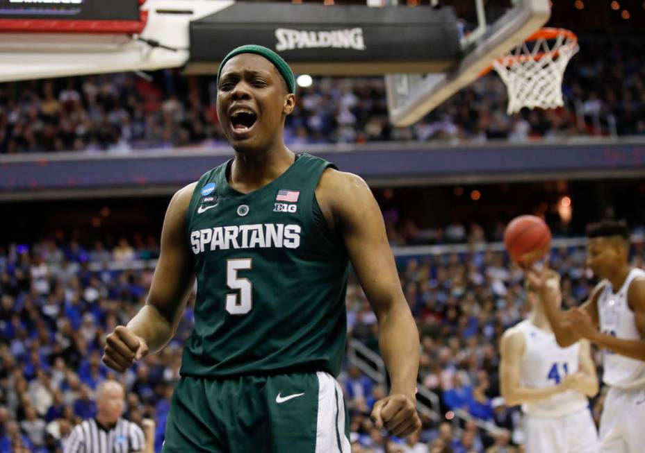 Michigan State guard Cassius Winston (5) reacts to scoring on Duke during the first half of an ...