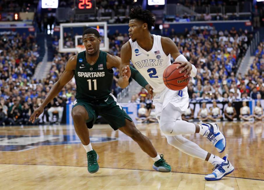 Duke forward Cam Reddish (2) drives around Michigan State forward Aaron Henry (11) during the f ...