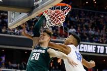 Michigan State guard Matt McQuaid (20) scores against Duke forward Javin DeLaurier (12) during ...