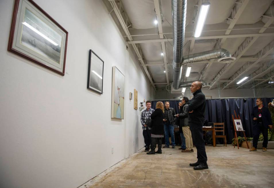 Paul Gonzales looks at the artworks on display at an exhibit at Core Contemporary Gallery in La ...