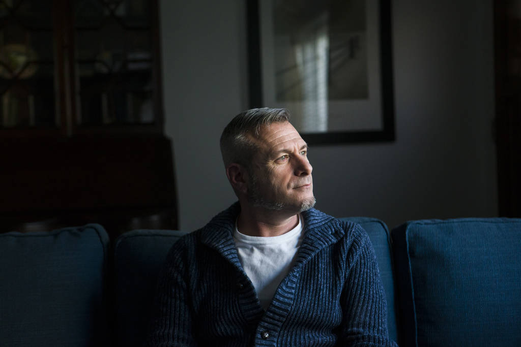 Jim Foley, who was diagnosed as HIV positive 30 years ago, poses for a portrait at his home in ...