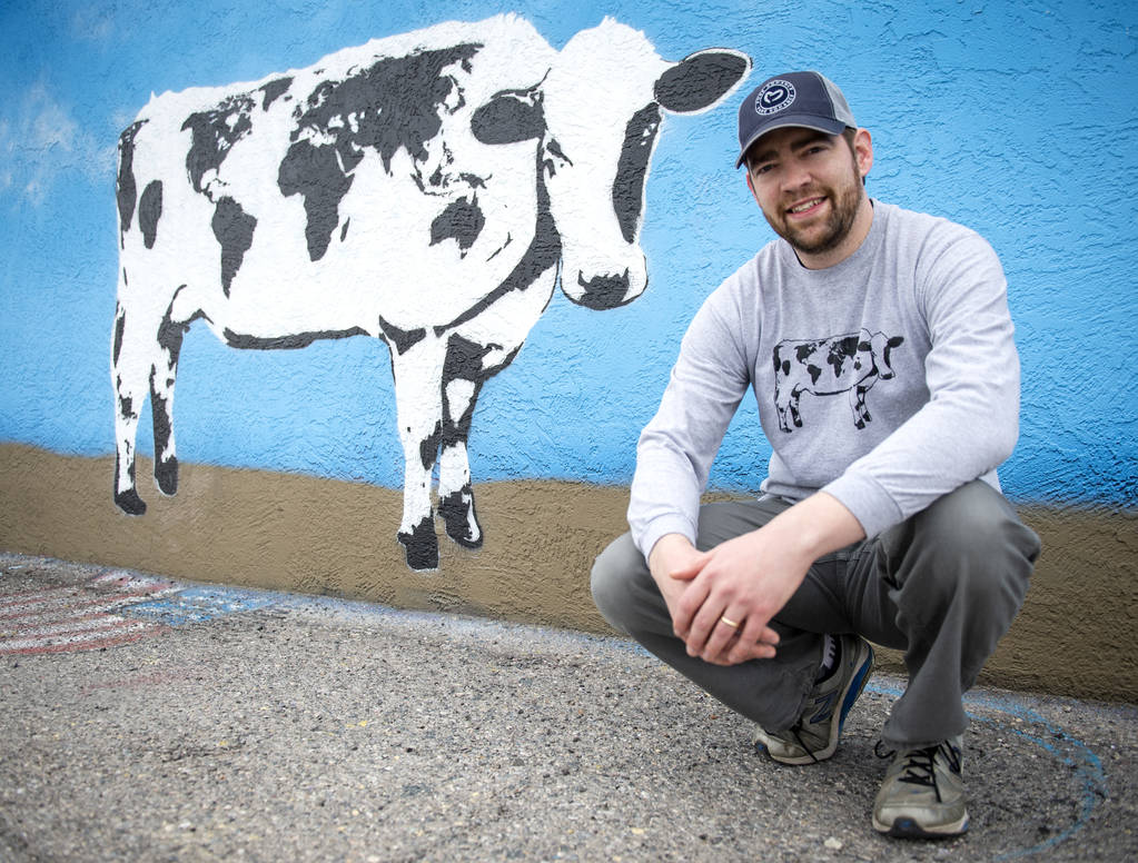 DJ Barry poses for a portrait in front of his mural located on the wall of Main Street Peddlers ...