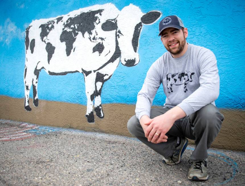 DJ Barry poses for a portrait in front of his mural located on the wall of Main Street Peddlers ...