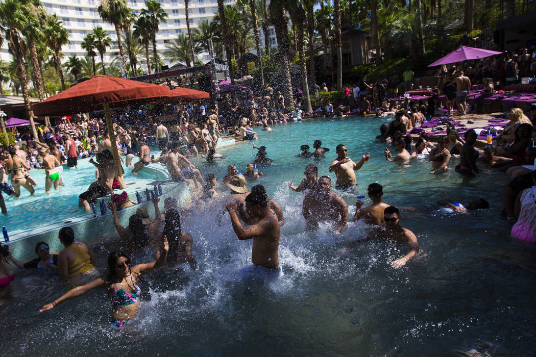 People splash and party in the pool at the Rehab dayclub at Hard Rock Hotel in Las Vegas on Sat ...