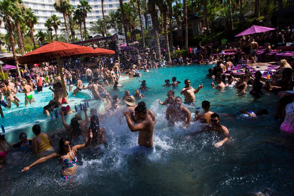 People splash and party in the pool at the Rehab dayclub at Hard Rock Hotel in Las Vegas on Sat ...