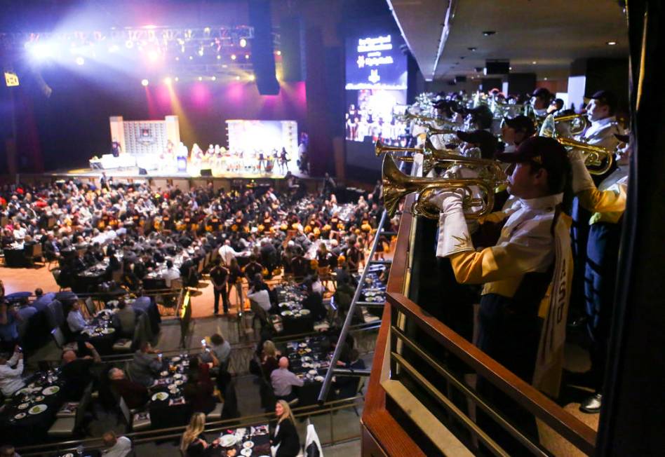 Members of the Arizona State marching band perform during the Las Vegas Bowl kickoff luncheon a ...