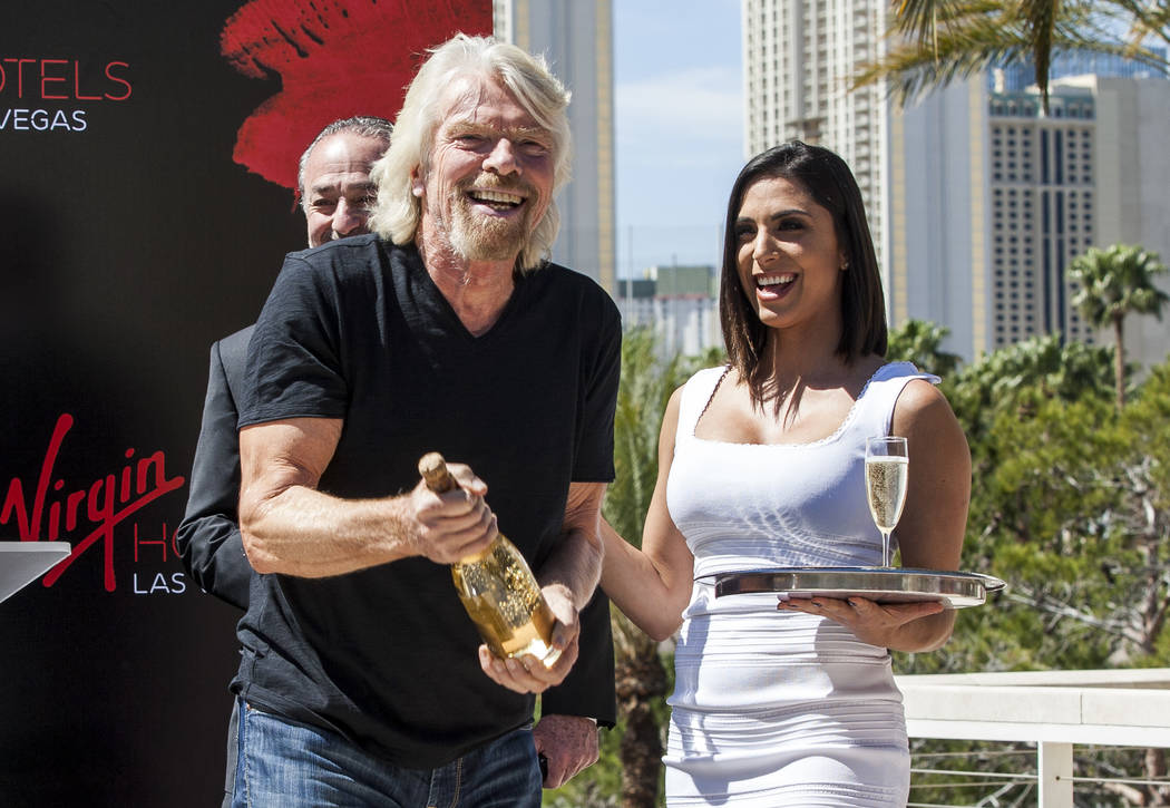 Virgin Group Founder Sir Richard Branson prepares for a champagne toast at a press conference a ...