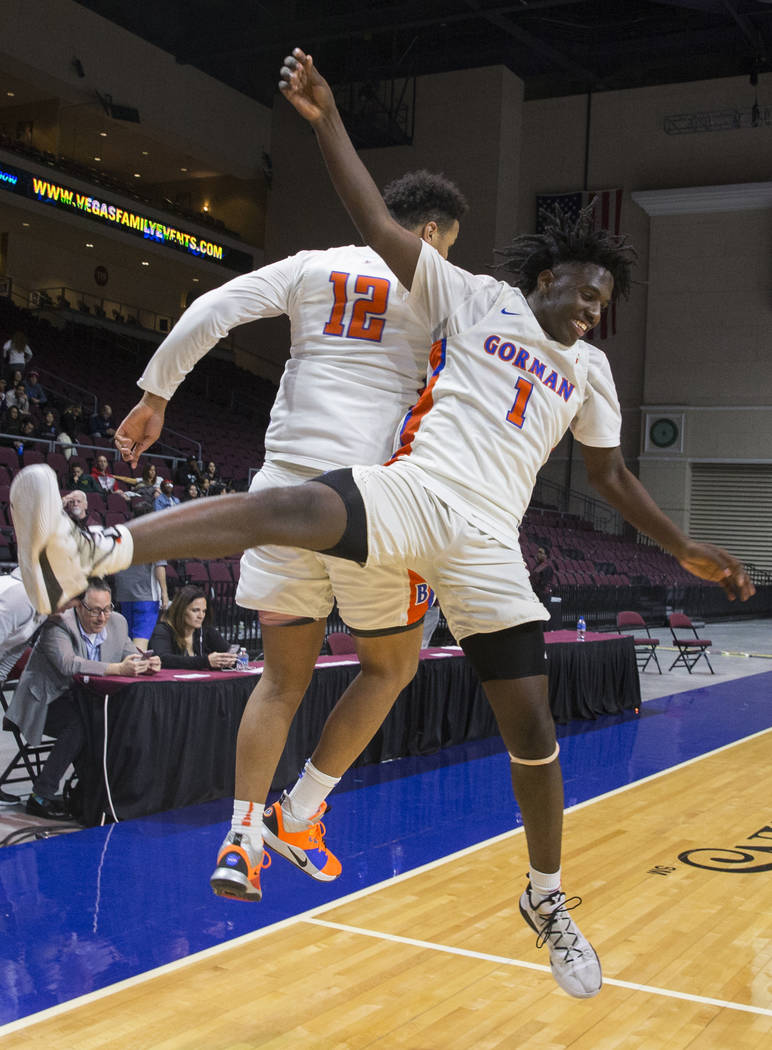 Bishop Gorman sophomore guard Will McClendon (1) and freshman forward Max Allen (12) celebrate ...